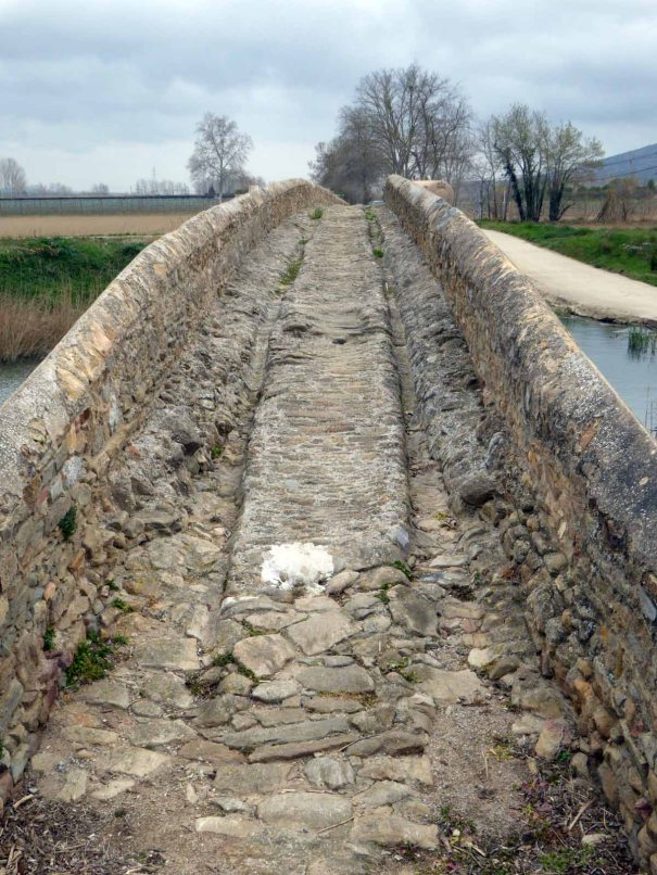 The bridge has been deeply ridged by decades of cart traffic.